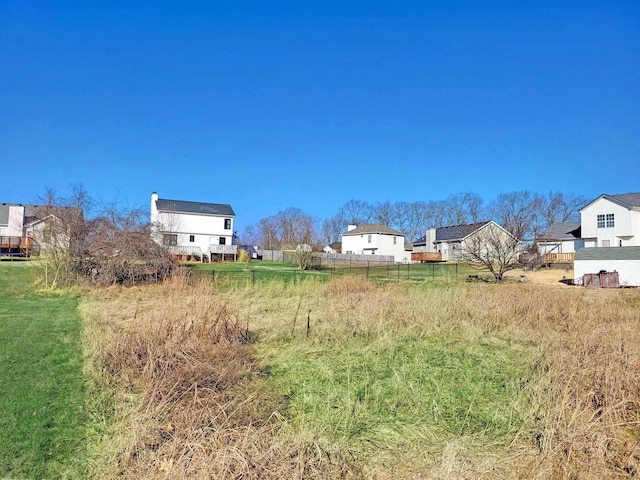 view of yard featuring a residential view and fence