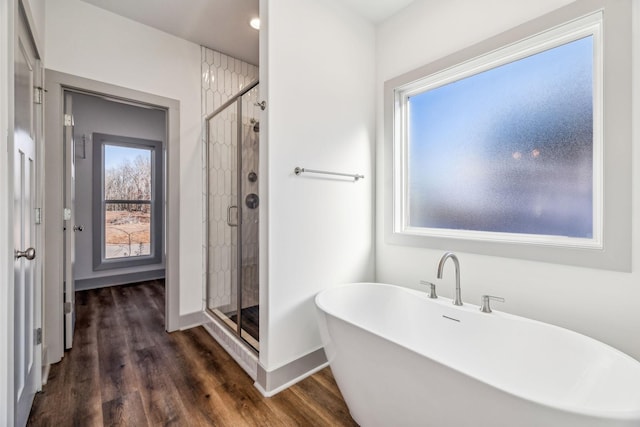 bathroom with separate shower and tub and wood-type flooring