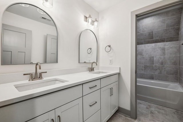 bathroom with vanity and tiled shower / bath combo