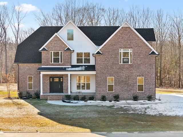 view of front of house featuring covered porch and a front yard