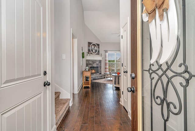 entryway with a fireplace, dark hardwood / wood-style floors, and lofted ceiling