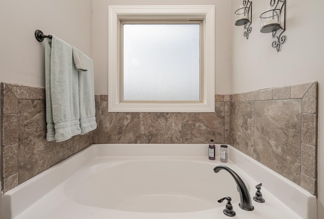 bathroom featuring a bathing tub and a wealth of natural light