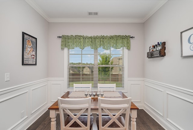 dining space with ornamental molding and dark wood-type flooring