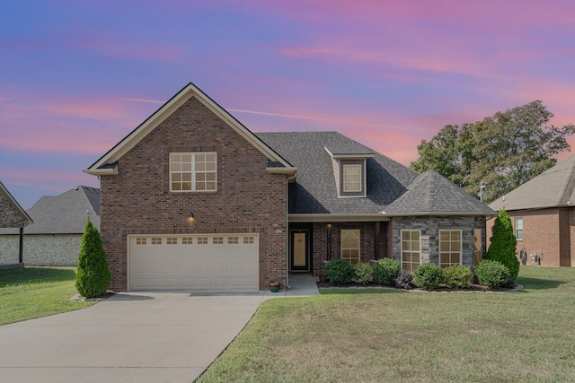 front facade featuring a garage and a lawn