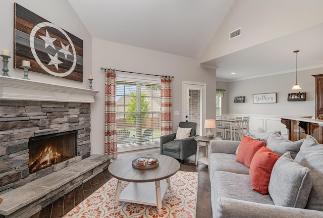 living room featuring dark hardwood / wood-style flooring, a stone fireplace, lofted ceiling, and crown molding