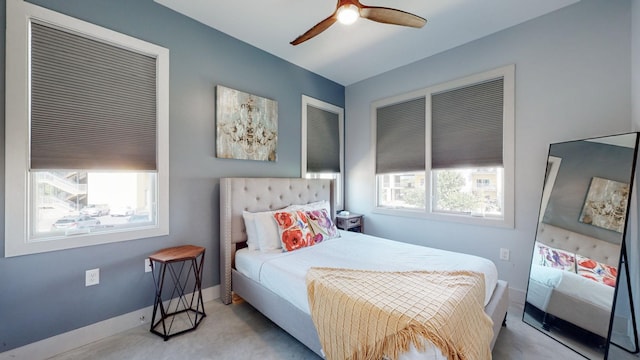 bedroom featuring light colored carpet and ceiling fan