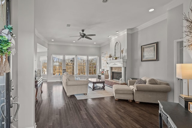 living room featuring ceiling fan, dark hardwood / wood-style floors, and ornamental molding