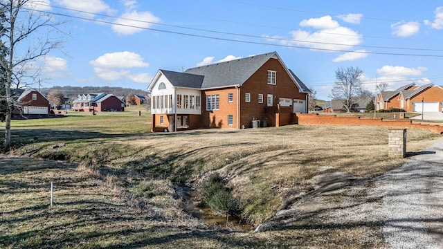 view of property exterior with a lawn and a sunroom