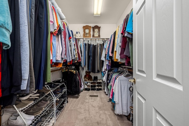 walk in closet with carpet floors