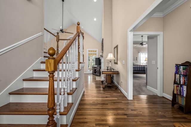 staircase with high vaulted ceiling, plenty of natural light, hardwood / wood-style floors, and ceiling fan