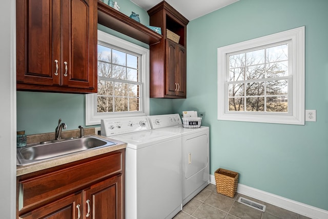 laundry area featuring sink, cabinets, independent washer and dryer, and light tile patterned flooring