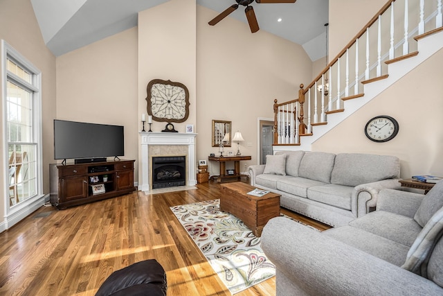 living room with ceiling fan, high vaulted ceiling, and hardwood / wood-style floors