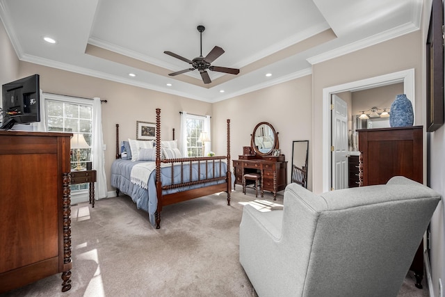 carpeted bedroom with ornamental molding, a raised ceiling, and ceiling fan