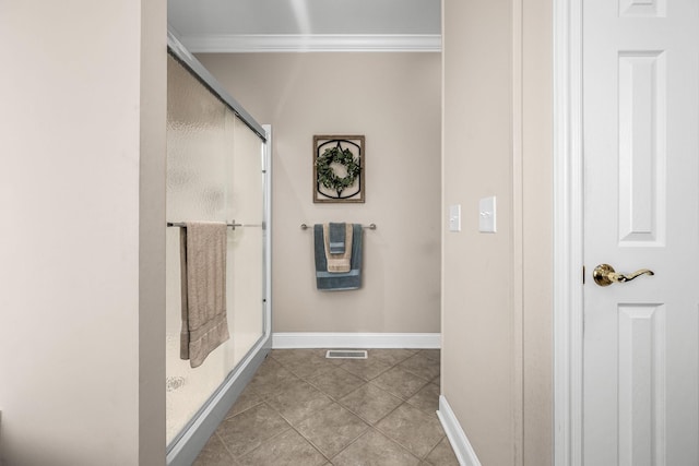 bathroom with ornamental molding, tile patterned floors, and a shower with shower door