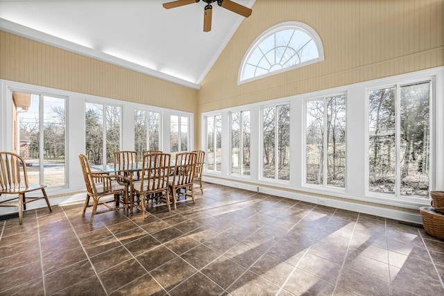 sunroom featuring a healthy amount of sunlight, vaulted ceiling, and ceiling fan