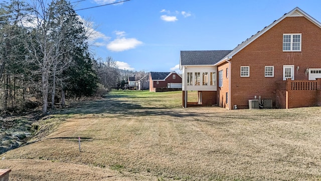 view of property exterior featuring cooling unit and a yard