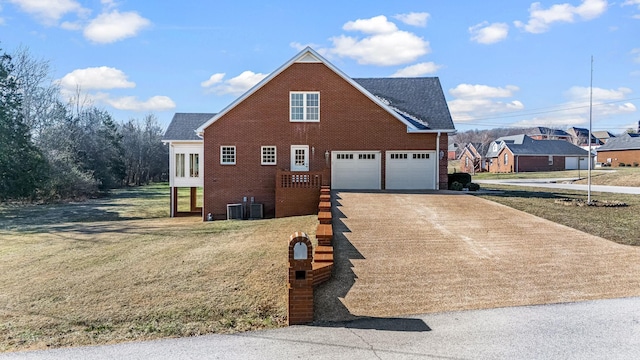 view of property with a garage and a front lawn