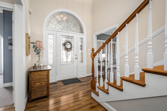 foyer with dark hardwood / wood-style floors and an inviting chandelier