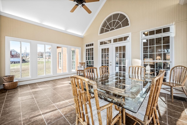 sunroom / solarium with lofted ceiling, a healthy amount of sunlight, ceiling fan, and french doors