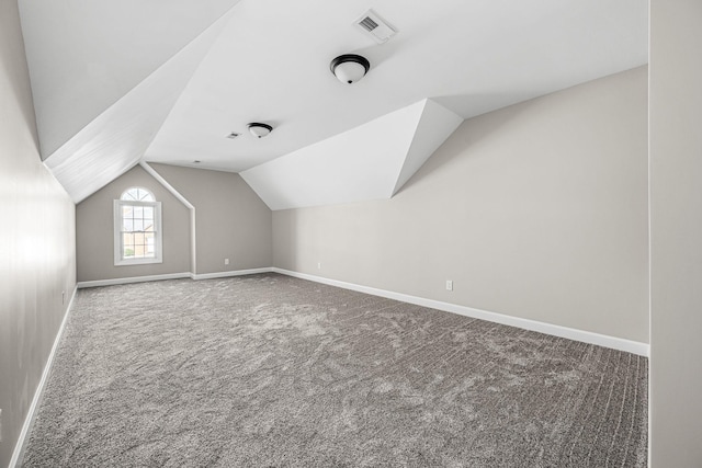 bonus room with lofted ceiling and carpet