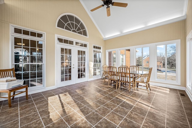 sunroom / solarium featuring vaulted ceiling, ceiling fan with notable chandelier, and french doors