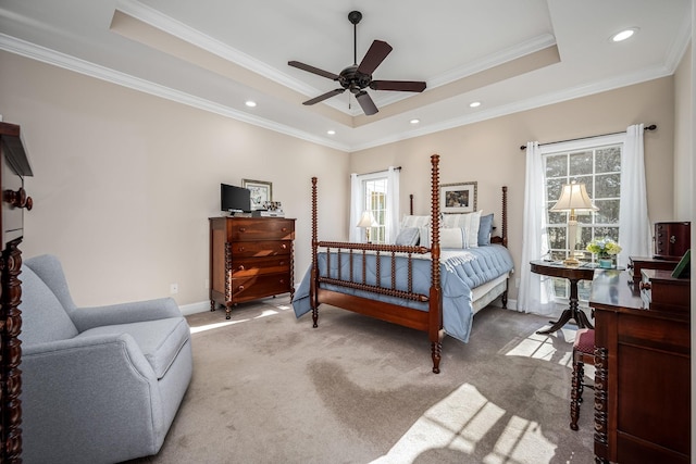 bedroom with a raised ceiling, ornamental molding, carpet flooring, and ceiling fan