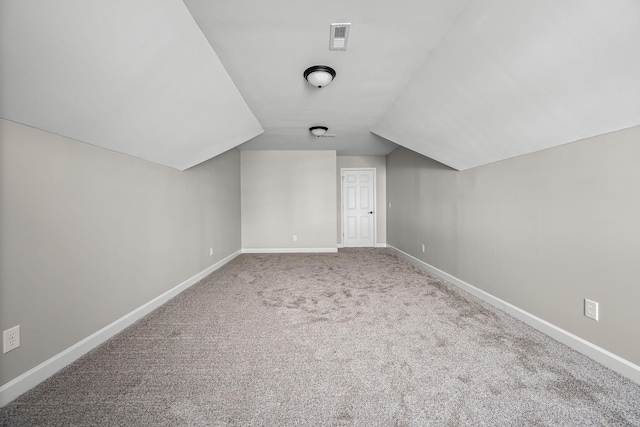 bonus room featuring lofted ceiling and carpet floors