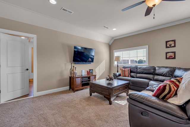 living room with ceiling fan, light colored carpet, lofted ceiling, and crown molding