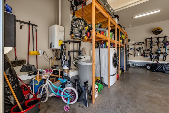 garage featuring washing machine and dryer and water heater