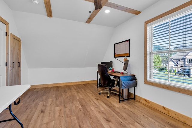 home office featuring vaulted ceiling and light hardwood / wood-style flooring