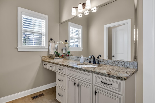 bathroom featuring tile patterned flooring and vanity