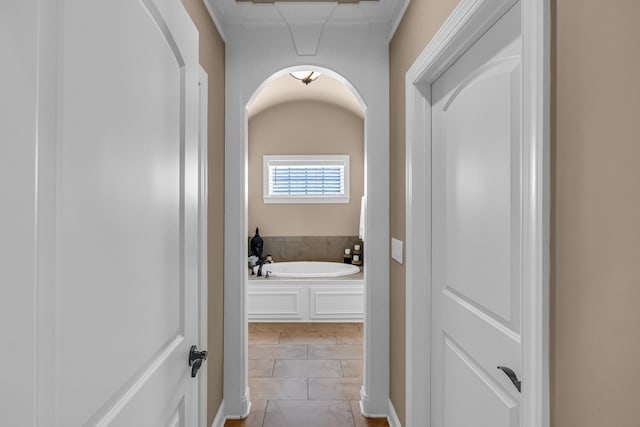 bathroom with tile patterned floors and a bathtub