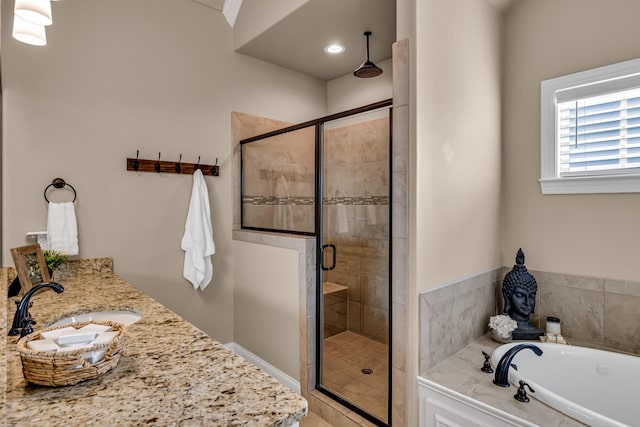 bathroom with shower with separate bathtub and vanity