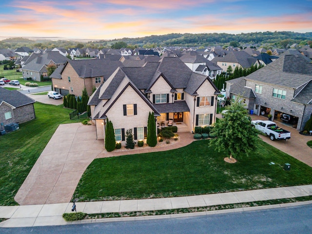 view of front of property with a lawn and central AC