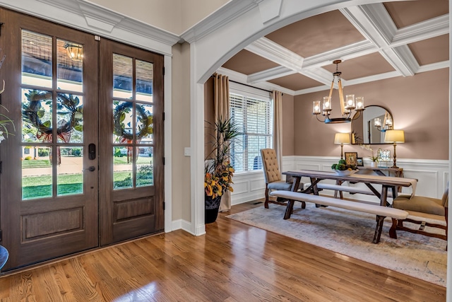 foyer entrance with beamed ceiling, french doors, crown molding, and coffered ceiling