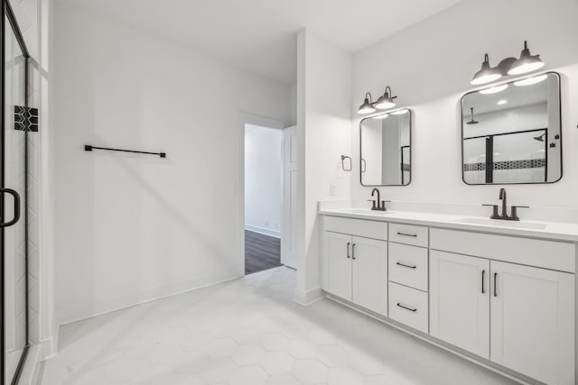 bathroom featuring tile patterned flooring, vanity, and a shower with shower door