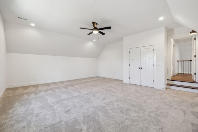 additional living space with light carpet, ceiling fan, and lofted ceiling