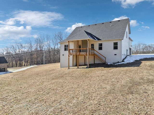 back of property with a deck and a yard