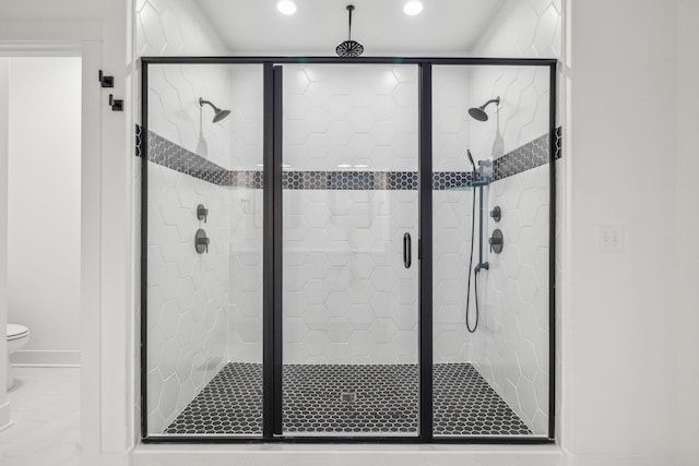 bathroom with toilet and walk in shower