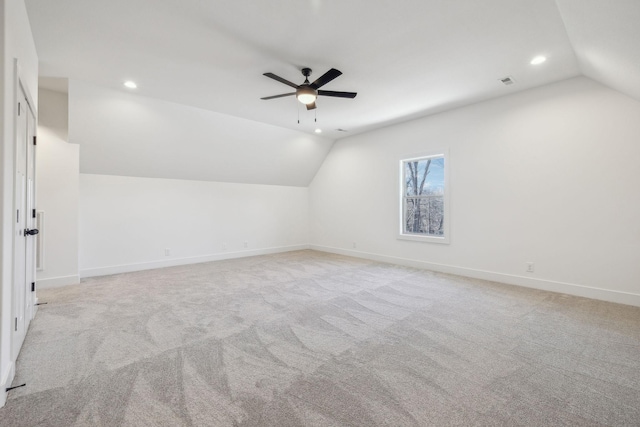 additional living space featuring light carpet, vaulted ceiling, and ceiling fan