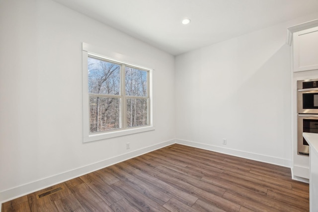 empty room featuring hardwood / wood-style flooring