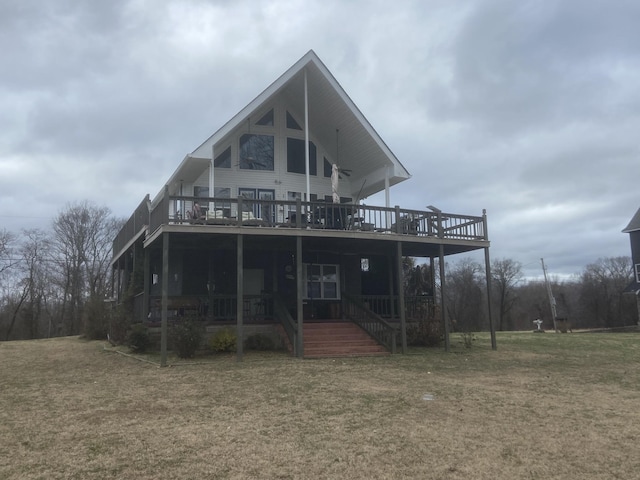 back of property featuring a yard and a wooden deck