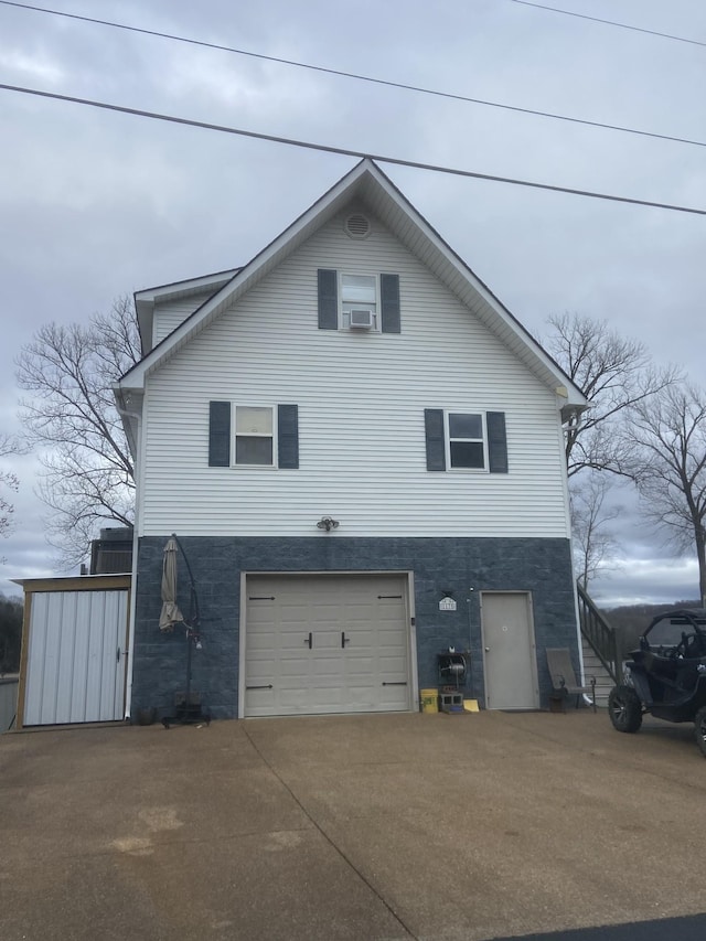 exterior space featuring cooling unit and a garage