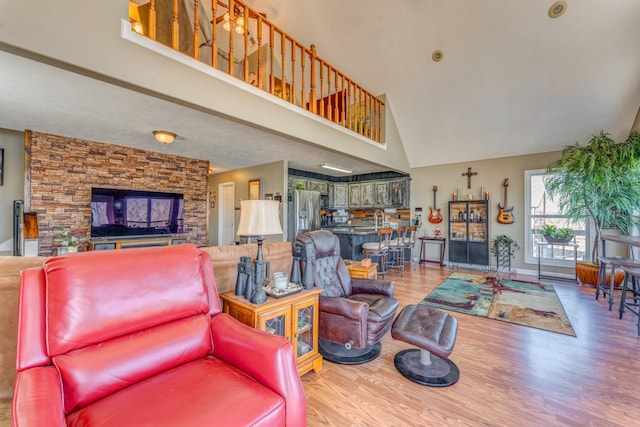 living room featuring hardwood / wood-style floors and high vaulted ceiling