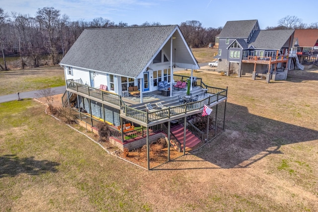 rear view of property with a yard and a deck