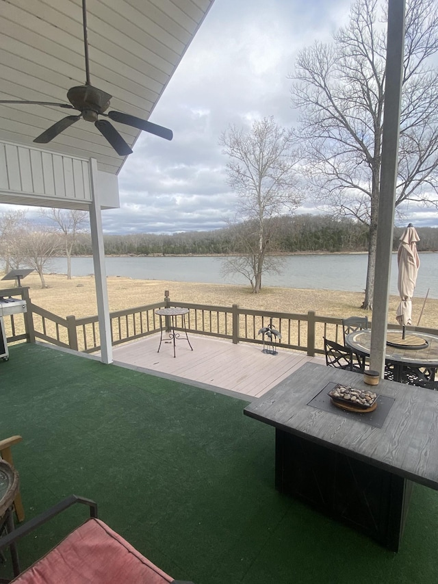 view of patio / terrace featuring ceiling fan and a deck with water view