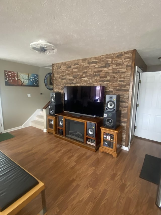 living room with hardwood / wood-style floors and a textured ceiling