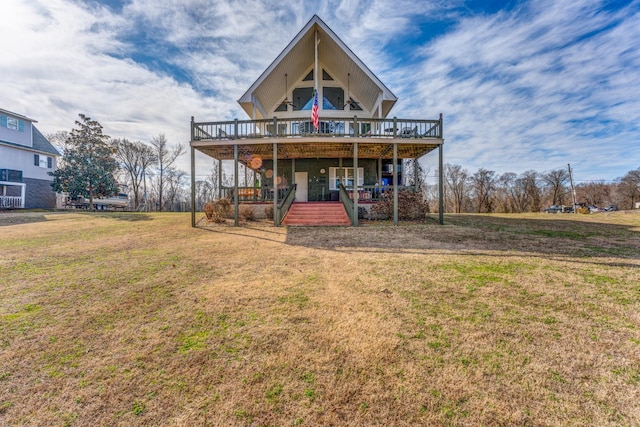 rear view of house with a wooden deck and a lawn