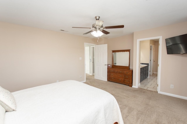 carpeted bedroom with ceiling fan and ensuite bath