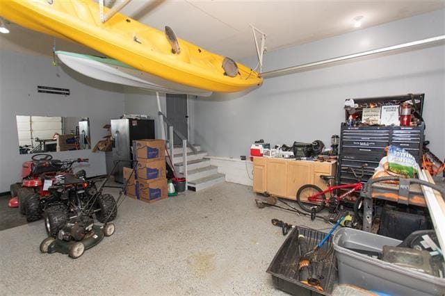 garage featuring stainless steel fridge with ice dispenser